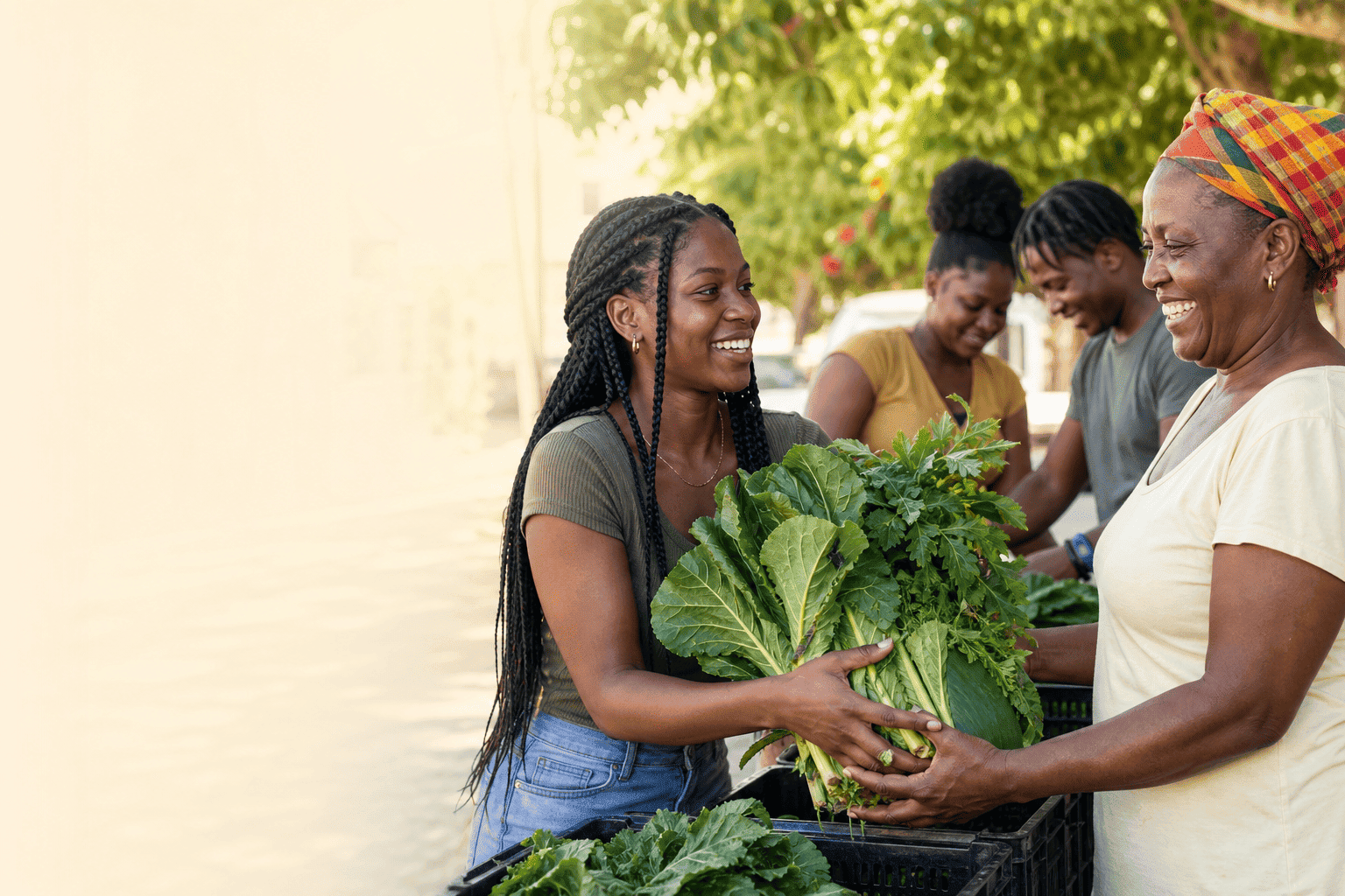 Neighbors sharing leafy produce at a community food distribution