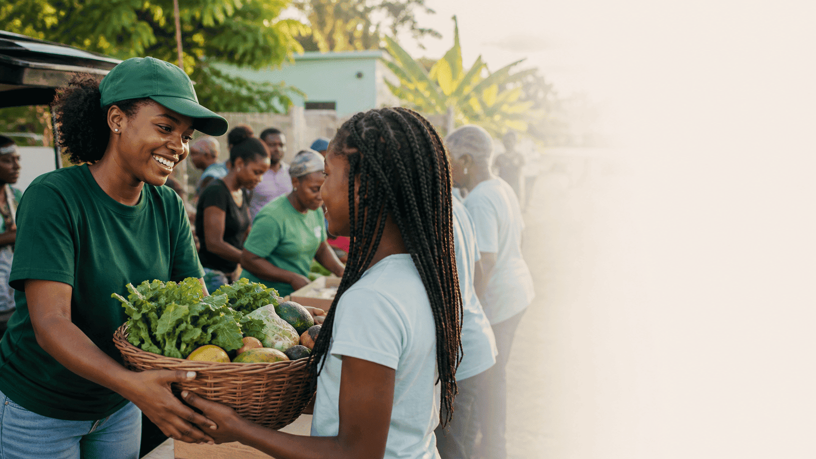 A volunteer handing a basket of fresh food to a young neighbor